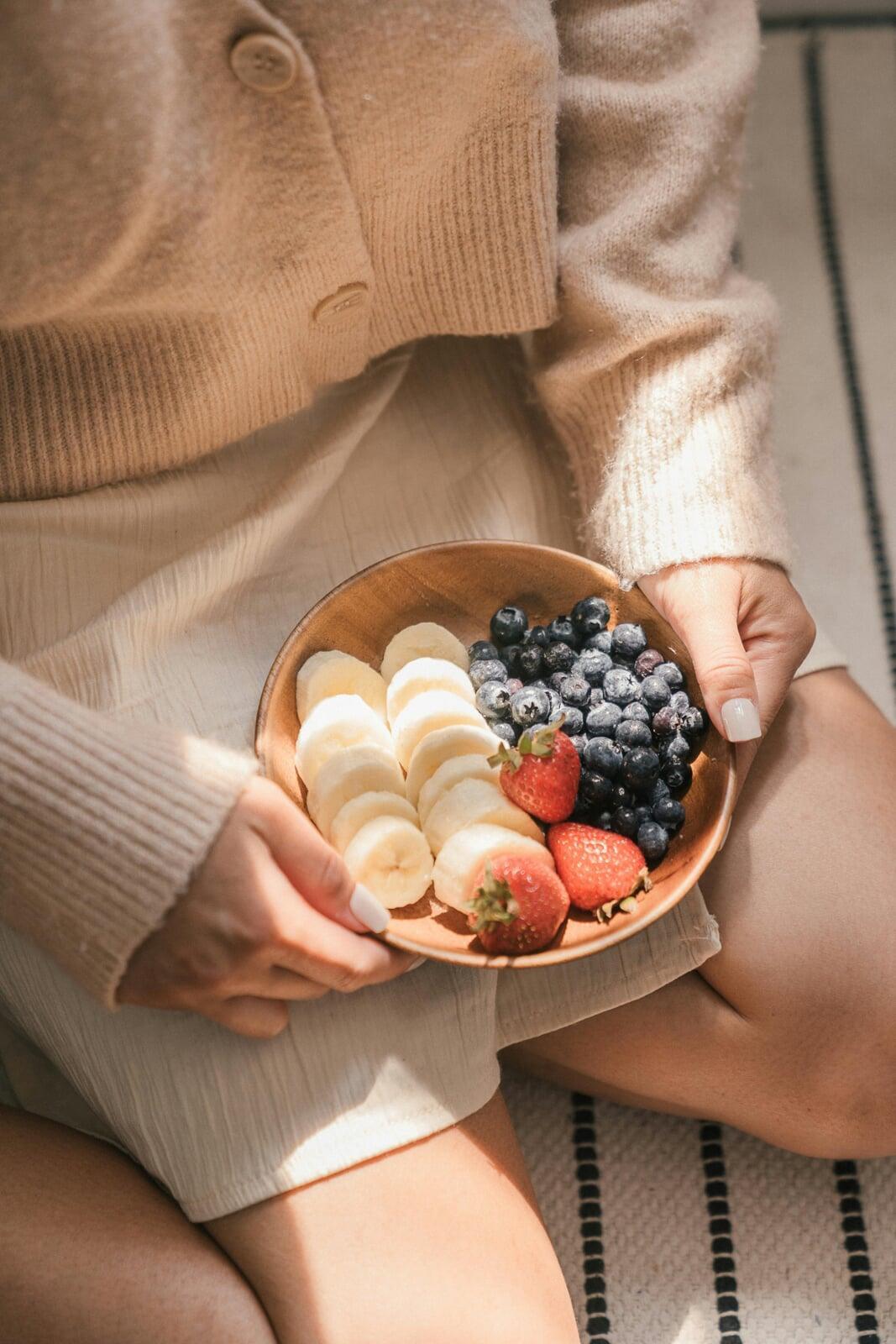 Happy Woman with fruit Bowl